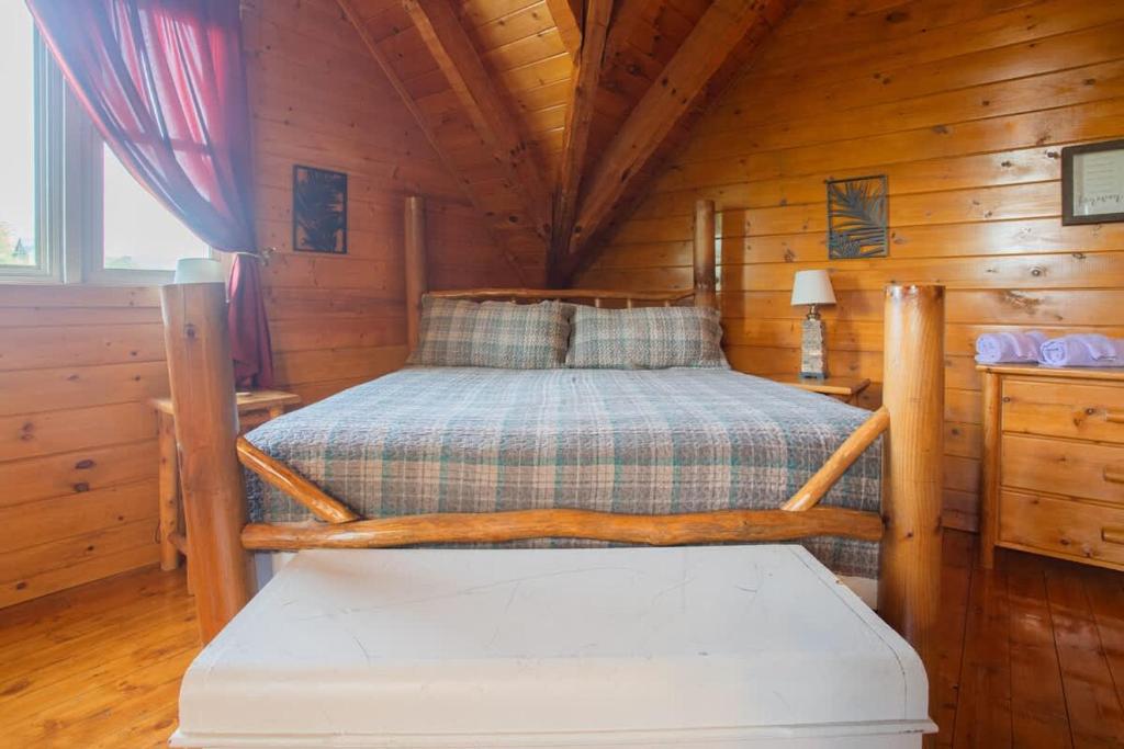 a bedroom with a bed in a wooden cabin at The Nut House in Sevierville