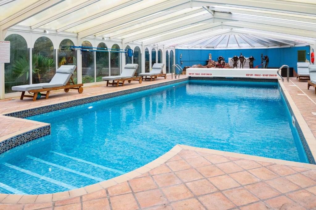 a large swimming pool with chairs and a building at 2 Bed in Brampton oc-c34637 in Brampton