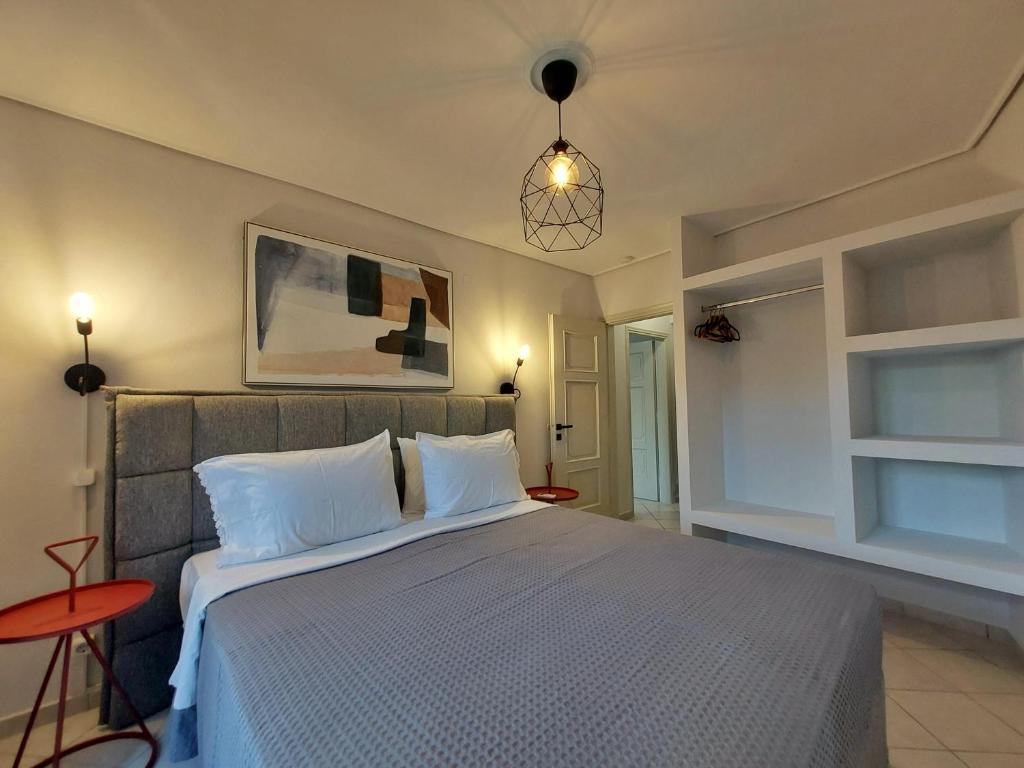 a bedroom with a large bed with white pillows at Margarita's Home in Steniaí