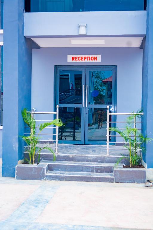a blue building with stairs leading to the door at Ramlat Service Apartment in Ilorin