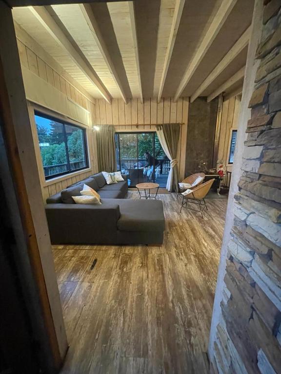 a large living room with a couch in a house at Casa punta de lobos in Pichilemu
