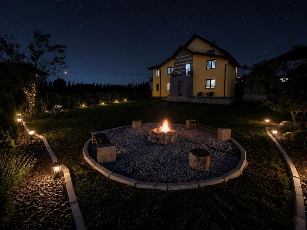 a fire pit in front of a house at night at Apartmani NINA Zlatar in Nova Varoš