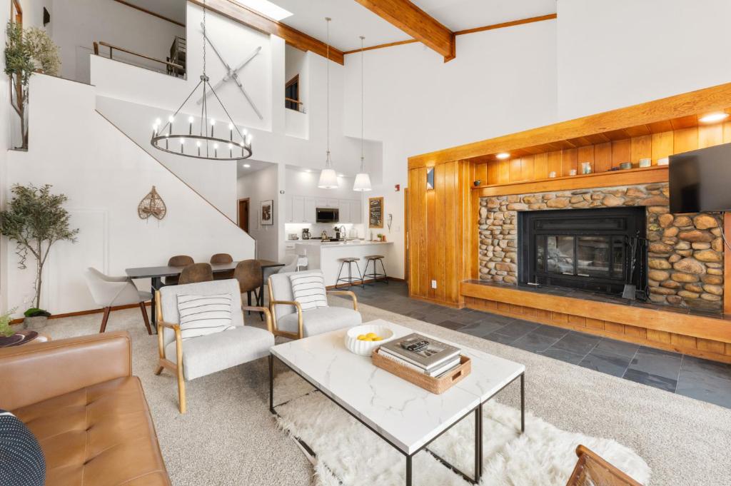 a living room with a table and a fireplace at Pines #2163 in Keystone