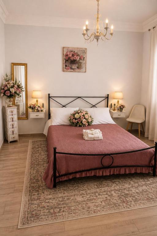 a bedroom with a large bed and a chandelier at Il Nido del Vicolo in Città della Pieve