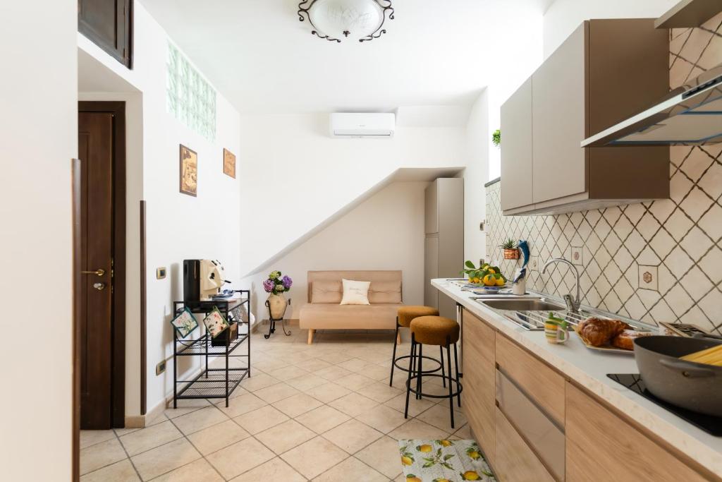 a kitchen with a counter and a living room at GrandPa's House in Sorrento