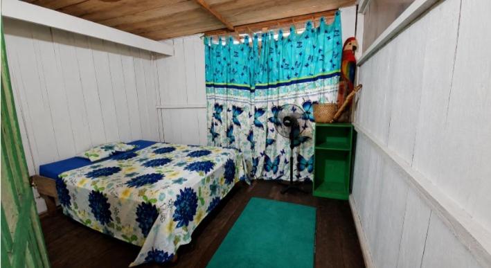 a small room with a bed and a dog in it at Macedonia Lodge in Macedonia