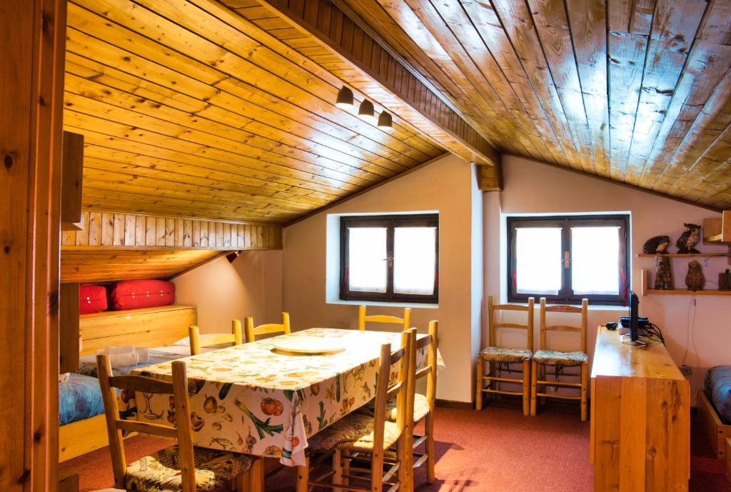 a dining room with a table and chairs at Pian delle Betulle Alpine Loft in Margno