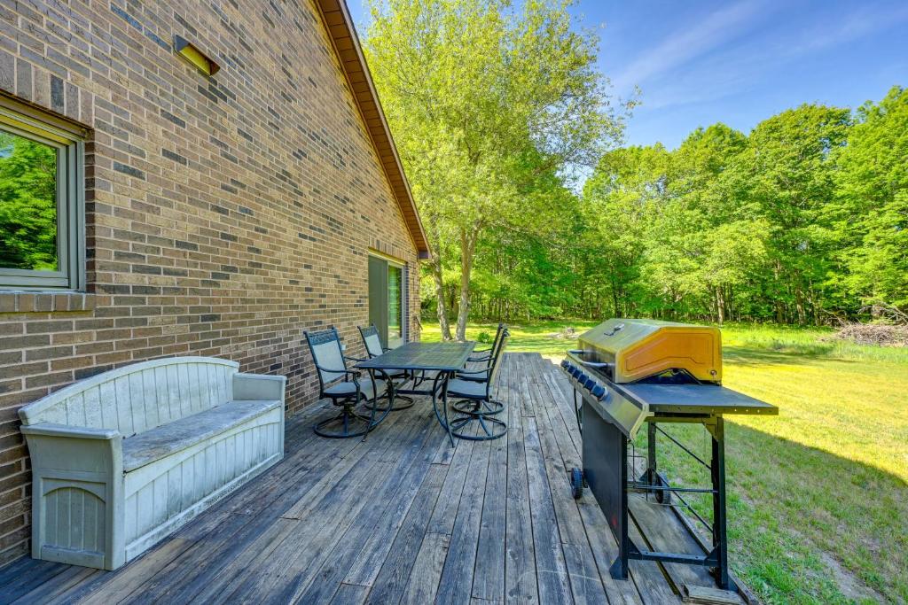 a patio with a grill and a table and chairs at Wooded Applegate Retreat w/ Private Trail Access in Applegate