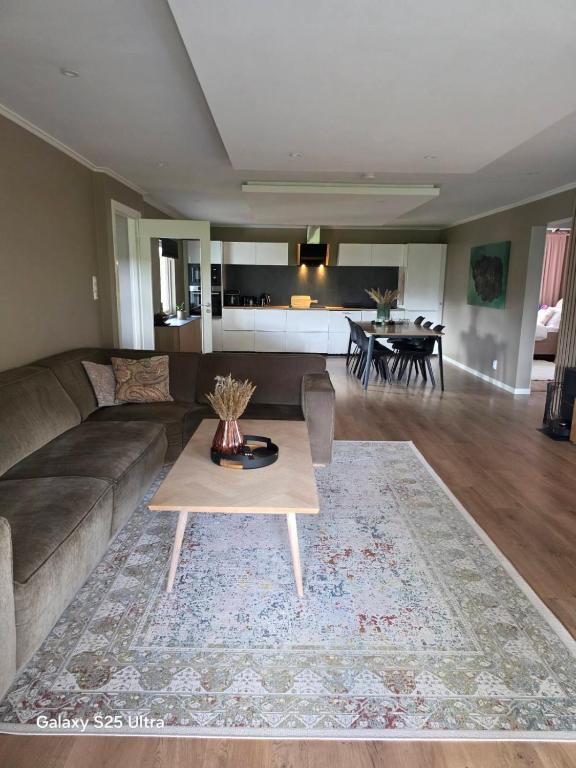 a living room with a couch and a table at Kristiansand Mosby1 in Kristiansand