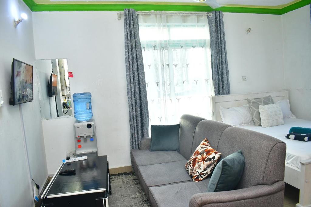 a living room with a couch and a bed at Oceanic Homes in Mombasa