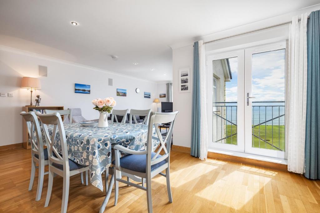 a dining room with a table and chairs at No18 The Links Apartment, Brora in Brora