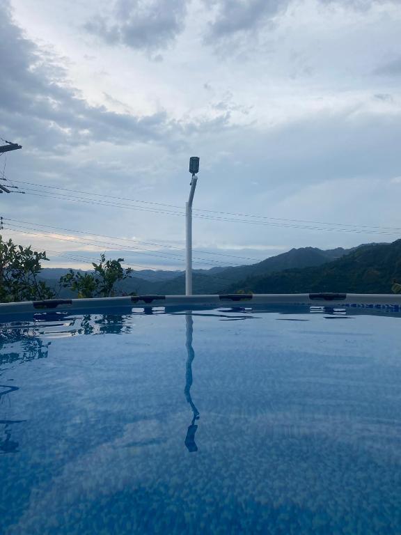 a swimming pool with a light pole in the distance at FInCA LA BENDICIÓN DE SUNNYVALE in La Vega