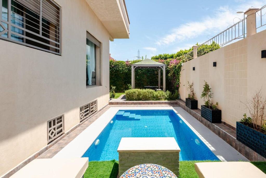 a swimming pool in the backyard of a house at Villa Sara, Piscine et Jardin privée in Marrakesh