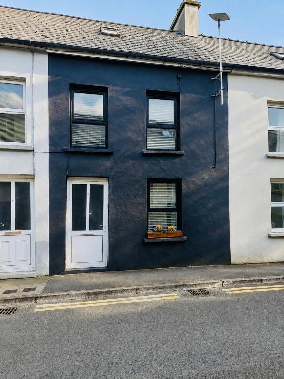 a blue and white house with a window at 4 Market Street in Bantry