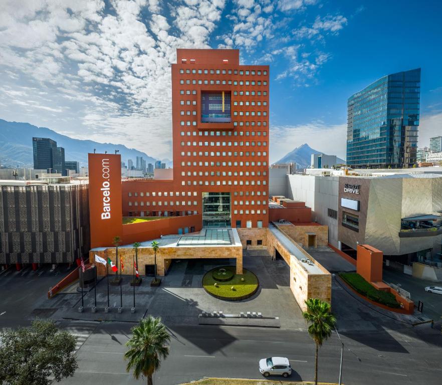 a building in a city with a parking lot at Barceló Monterrey Valle in Monterrey