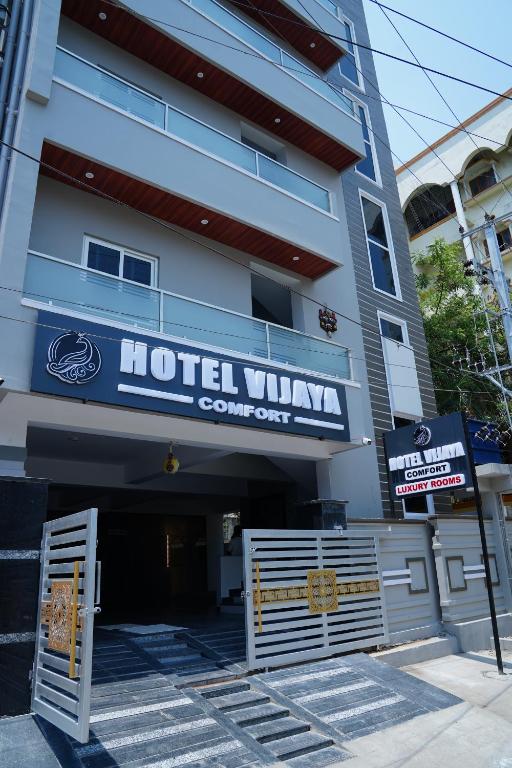 a hotel villa with a sign in front of it at Hotel Vijaya Comfort in Hyderabad