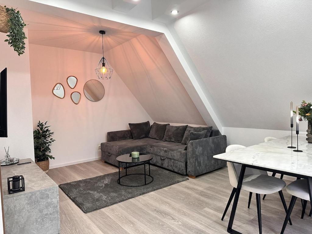 a living room with a couch and a table at Modernes Apartment am Bodensee in Singen