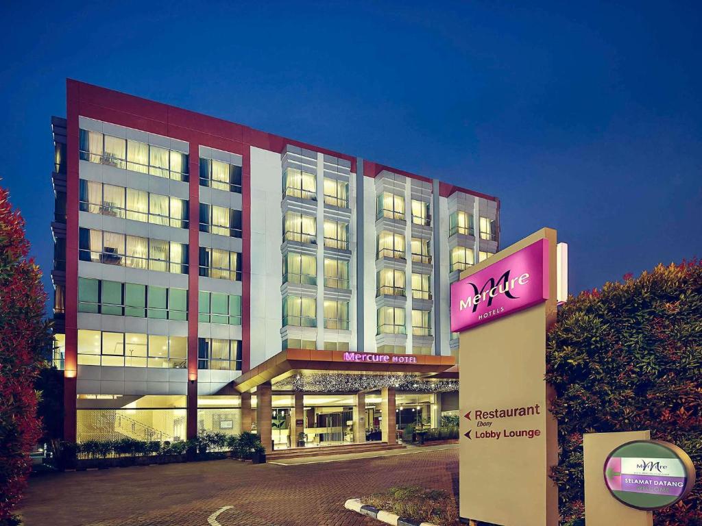 a large building with a sign in front of it at Mercure Pontianak City Center in Pontianak