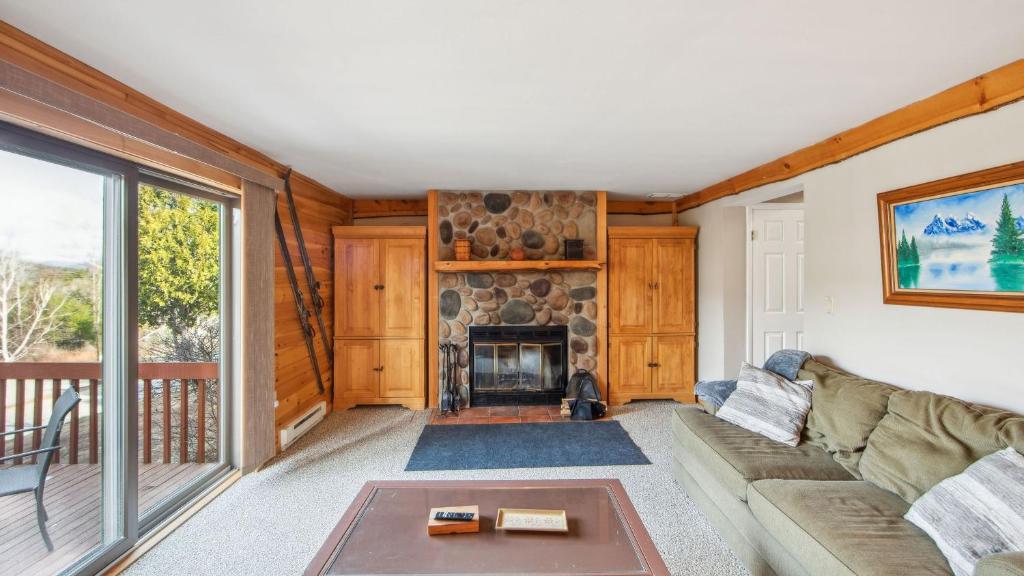 a living room with a couch and a fireplace at Echo by AvantStay in North Creek