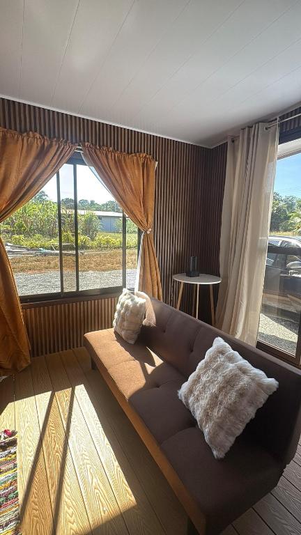 a living room with a couch and a large window at Leha's Apartaments in Buenos Aires