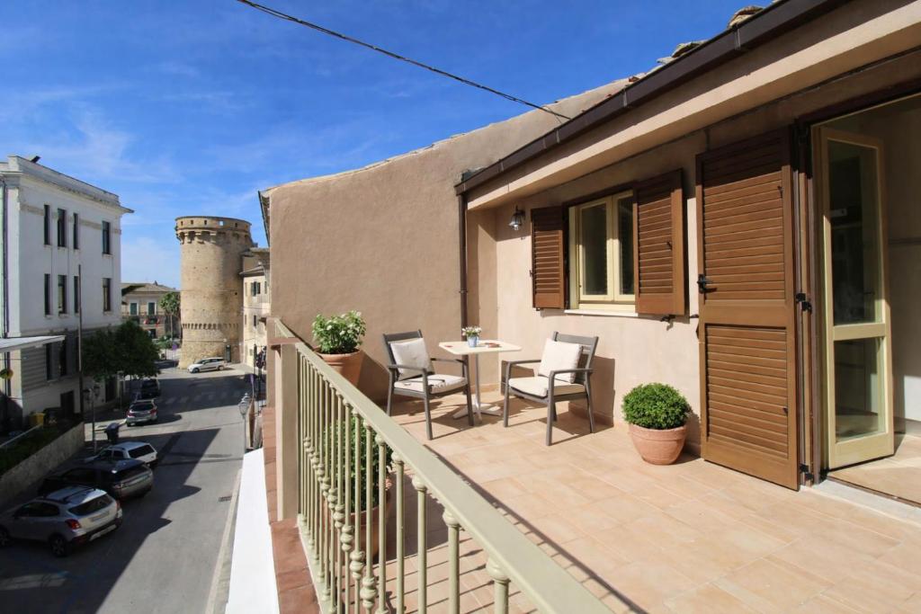 a balcony with a table and chairs on a building at Casa Conti Trivelli 2 in Vasto