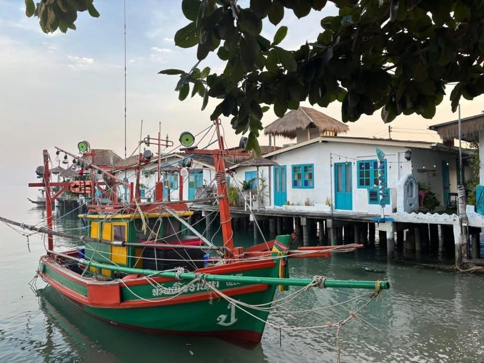 a boat is docked next to a pier at The Boathouse in Bang Sare