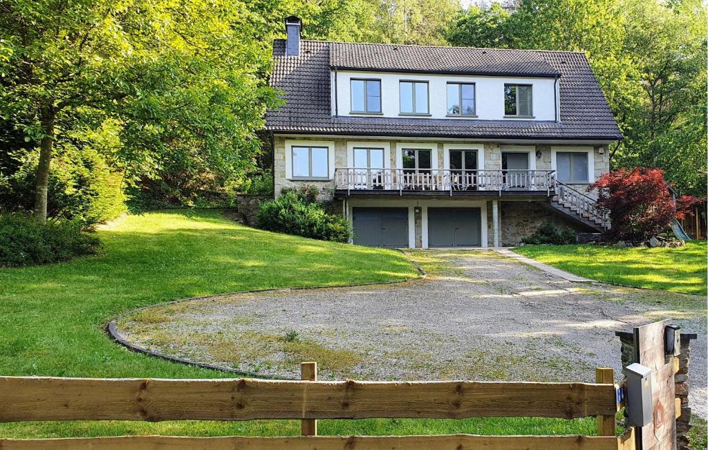 a large house with a fence in front of it at Le Petit Verger in Waimes