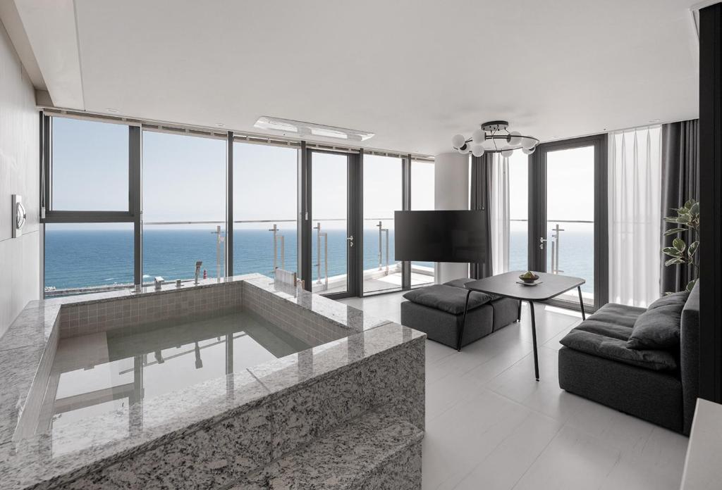 a living room with a view of the ocean at Plott The Gak Yangyang in Yangyang