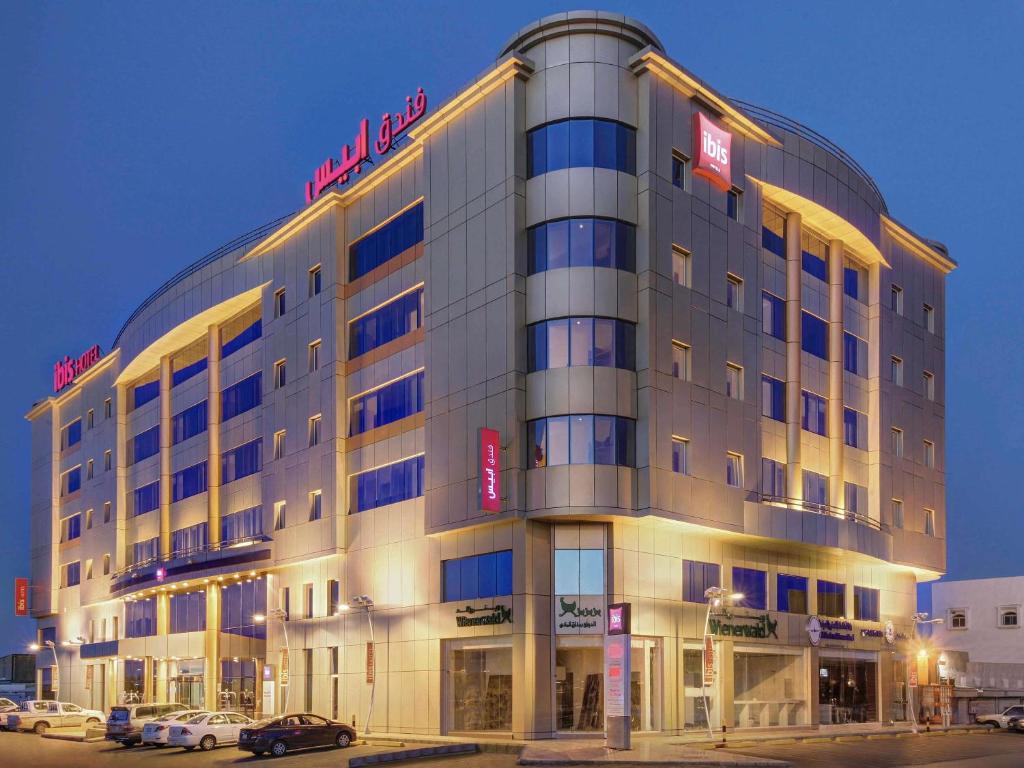 a large building with a sign on top of it at Ibis Yanbu in Yanbu