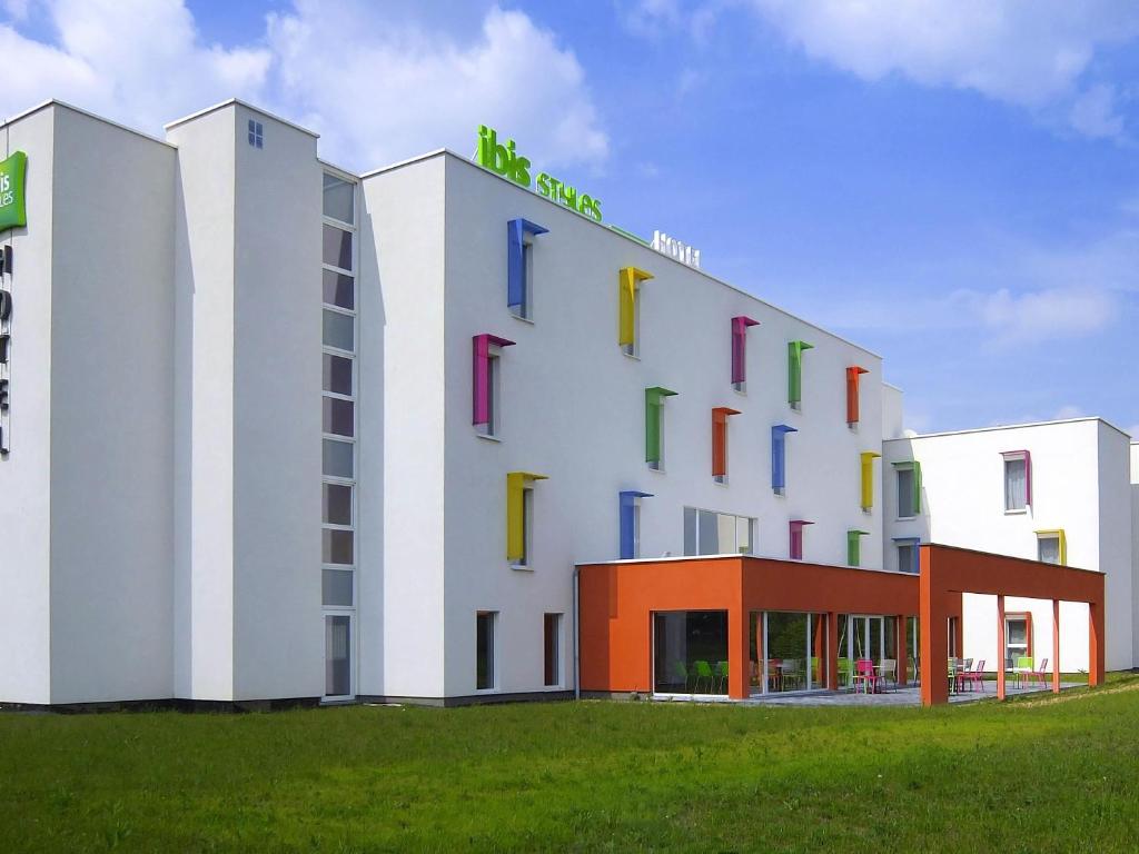 a building with colorful windows on the side of it at Ibis Styles Nivelles in Nivelles