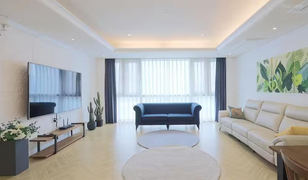 a living room with a couch and a tv at BS Centum hotel in Busan