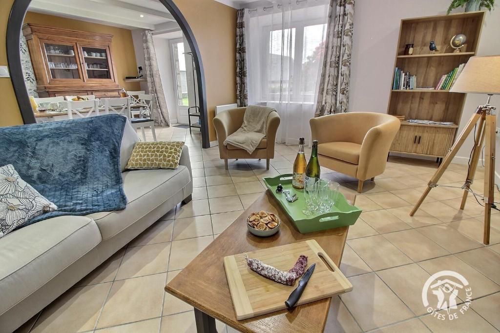 a living room with a couch and a table at Kerlic in Ploubazlanec