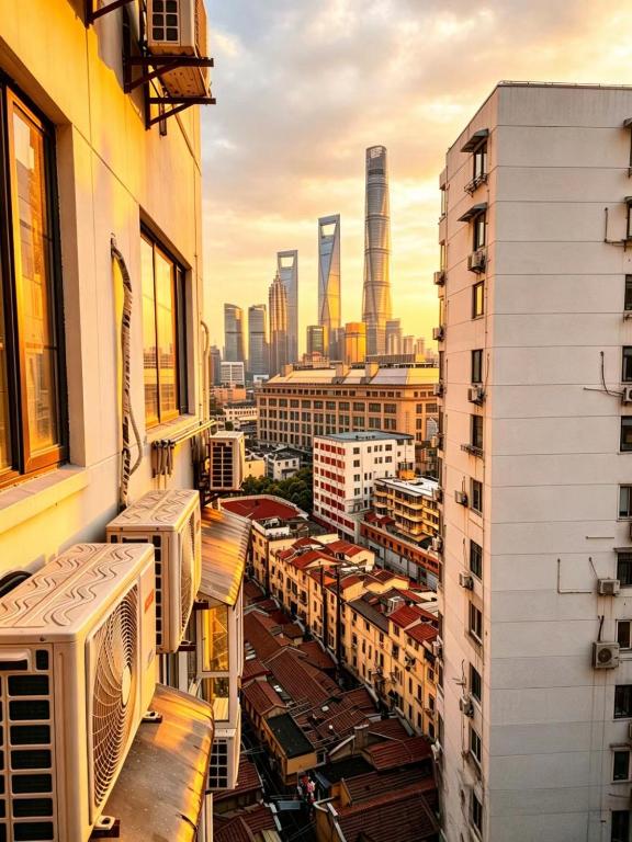 a view of a city from a balcony with buildings at Pine & Cedar Suites – Hua Xiao Ye in Shanghai