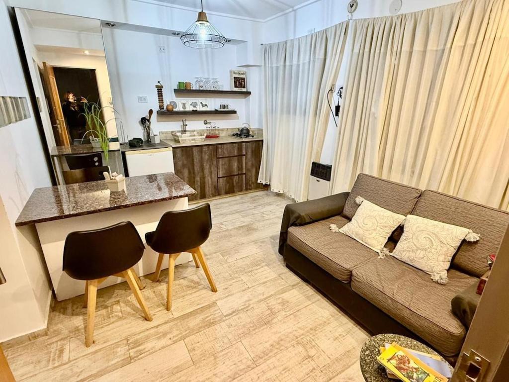 a living room with a couch and a kitchen at Mini departamento LUMIC II in Santa Fe
