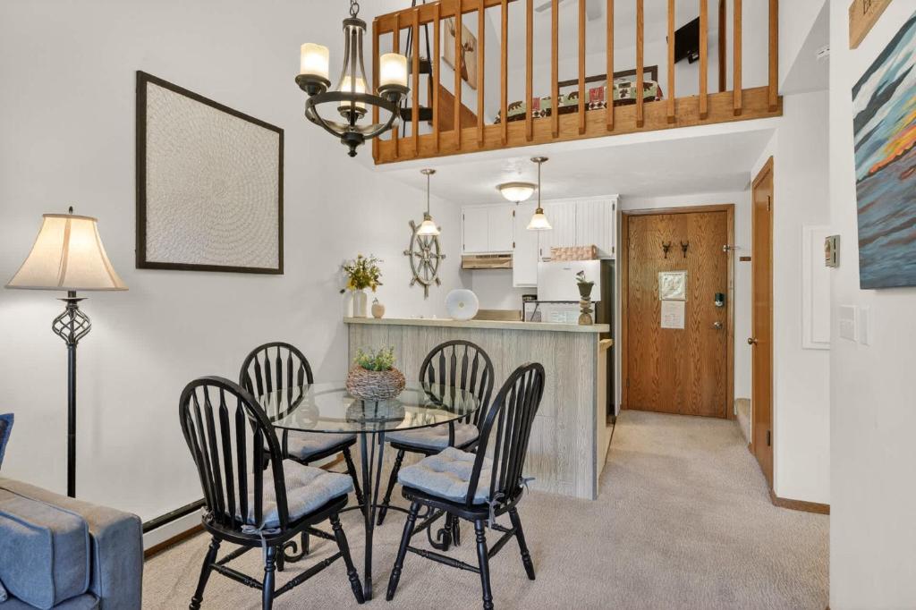 a dining room and kitchen with a table and chairs at Cedar Haven Unit 202 by Simple Life Rentals in Ephraim