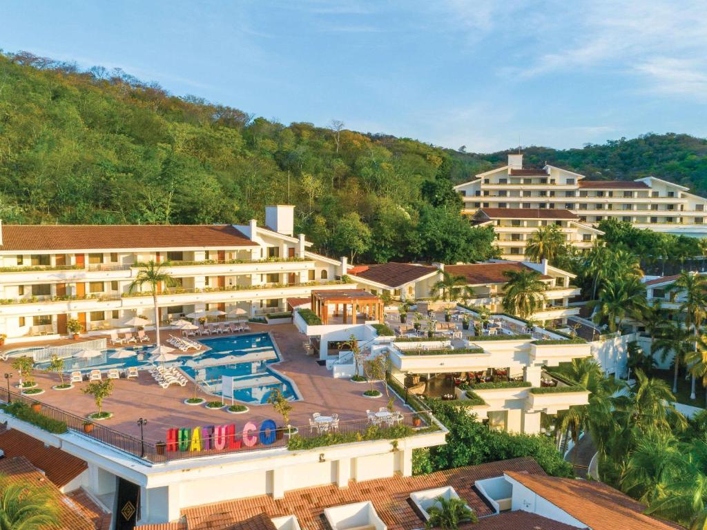 an aerial view of a resort with a swimming pool at Park Royal Beach Huatulco in Tangolunda