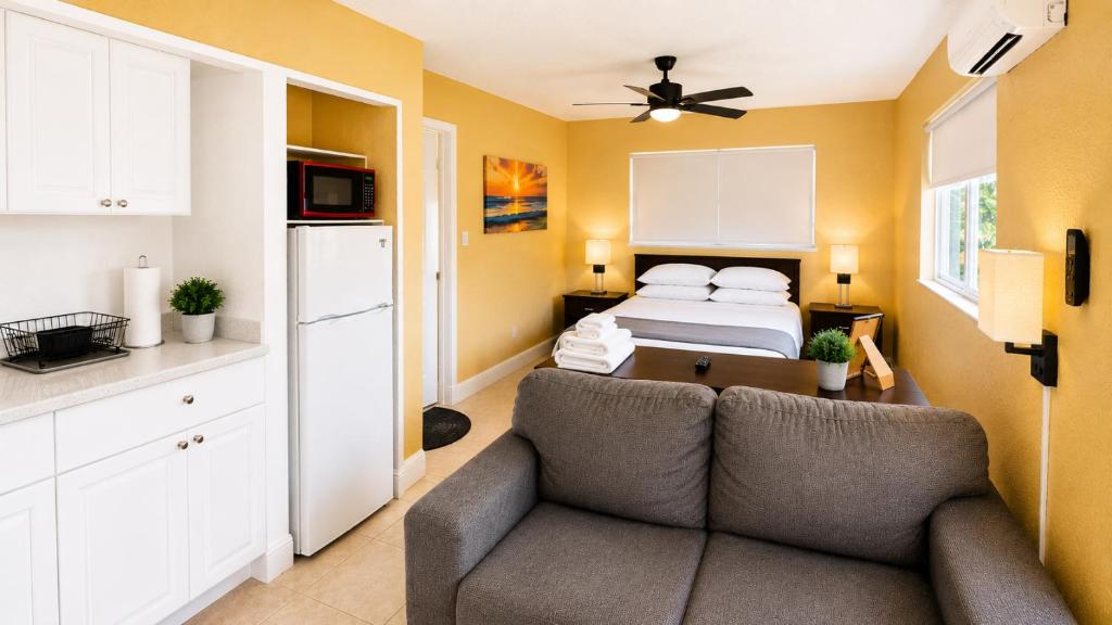a living room with a couch and a bed at Private Guest Suite with Separate Entrance & Kitchen in Lauderdale Lakes