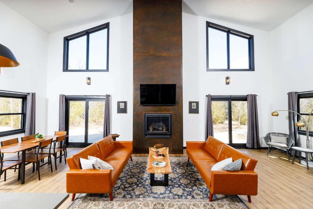 a living room with couches and a fireplace at Flint Ridge in Sister Bay