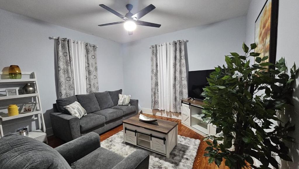 a living room with a couch and a ceiling fan at Peabody short term rental in Staunton