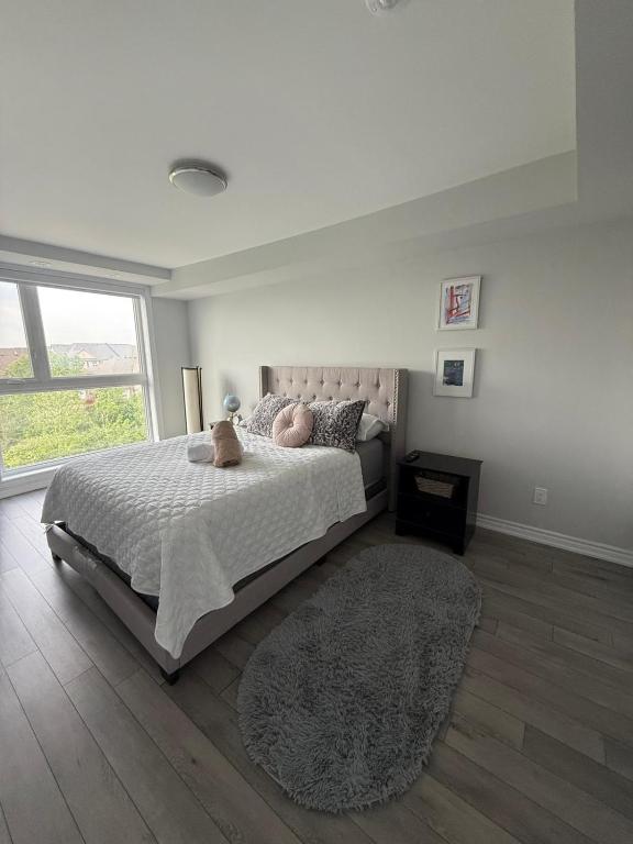 a bedroom with a bed with a teddy bear on it at Oakville Townhouse Amazing Rooftop in Oakville