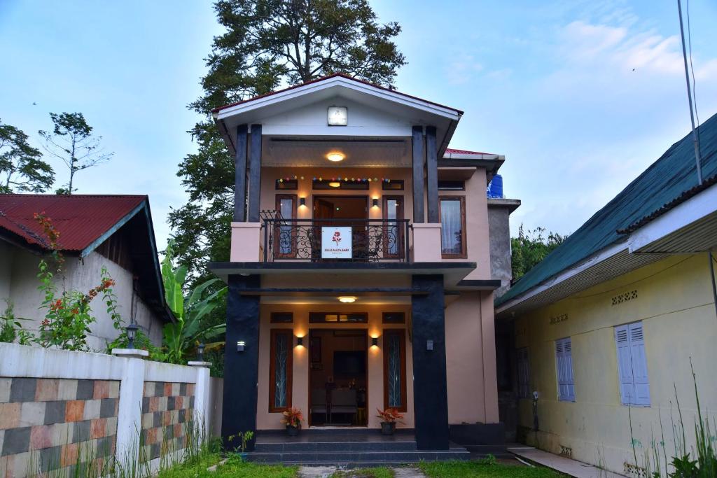 a house with a balcony on top of it at Elle Maya Sari Residence in Kotabaru