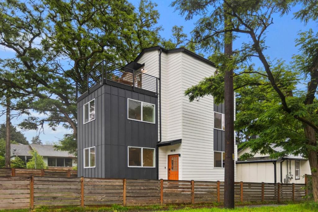 a black and white house with a tree at Modern House in Seattle in Seattle