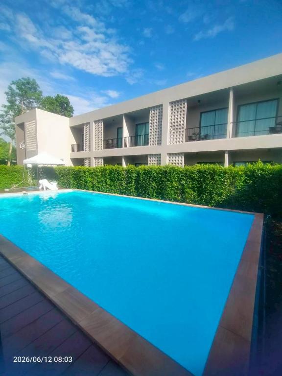 a large swimming pool in front of a building at The Camp in Kanchanaburi City