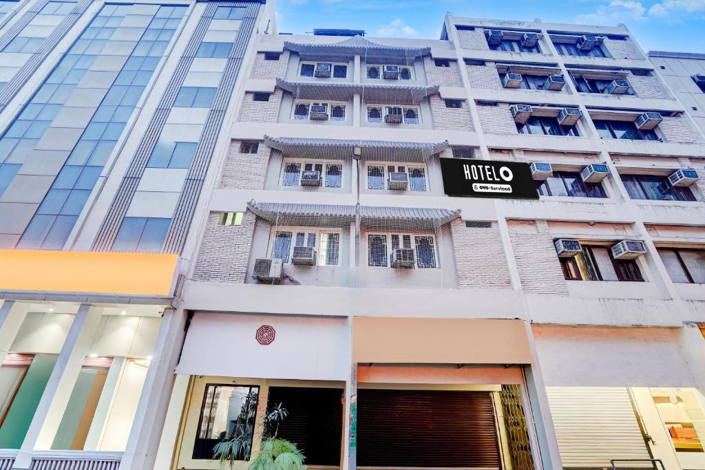 a tall building with a nikko sign on it at Super Hotel O by OYO Clock Tower Ludhiana Formerly Greatwall in Ludhiana