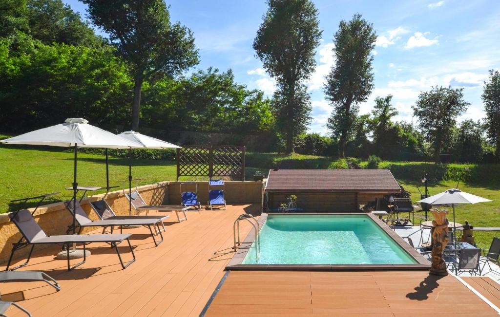 a swimming pool with chairs and umbrellas next to at Beautiful Home In Arezzo in Arezzo