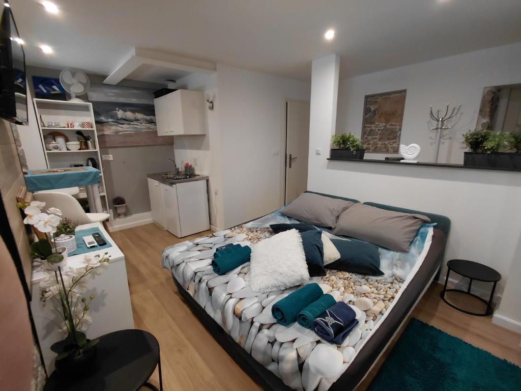 a living room with a couch with pillows on it at Apartman Barocco Lovran in Lovran