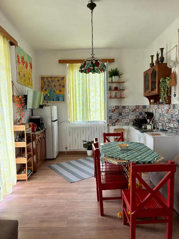 a kitchen with a table and a dining room at Almadovarhouse in Makhinjauri