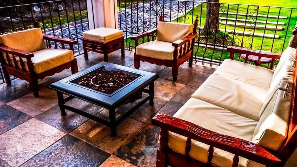 a group of chairs and a coffee table on a balcony at Ex Hacienda Santa Elena in Atlixco