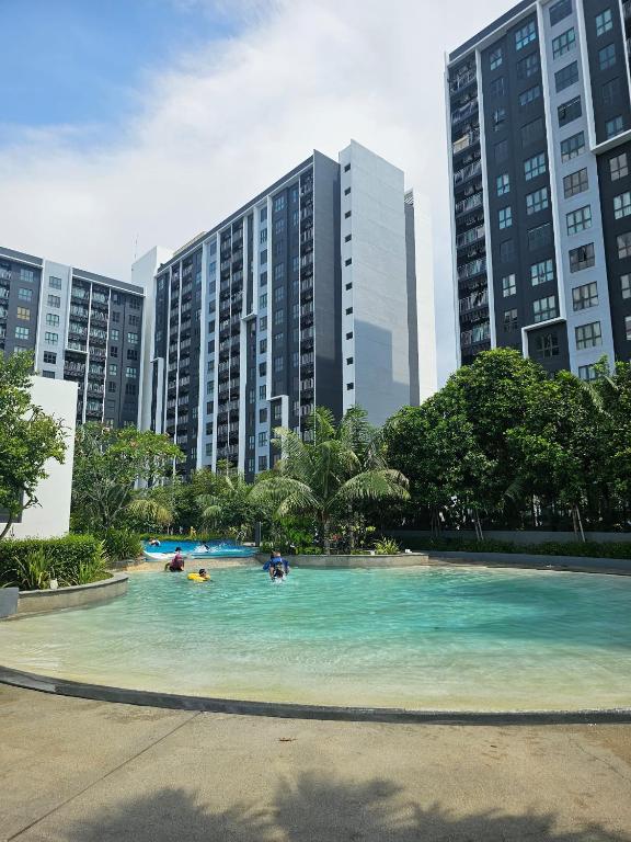 a swimming pool in a city with tall buildings at Maru Maya Bay Guest House in Banting