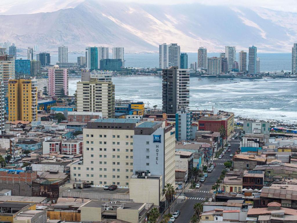 an aerial view of a city with a mountain at ibis budget Iquique in Iquique